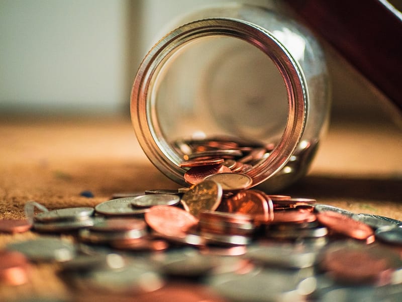 Why Most Small Businesses Fail: The Secret is Cash Flow 1 coins falling out of tipped over jar